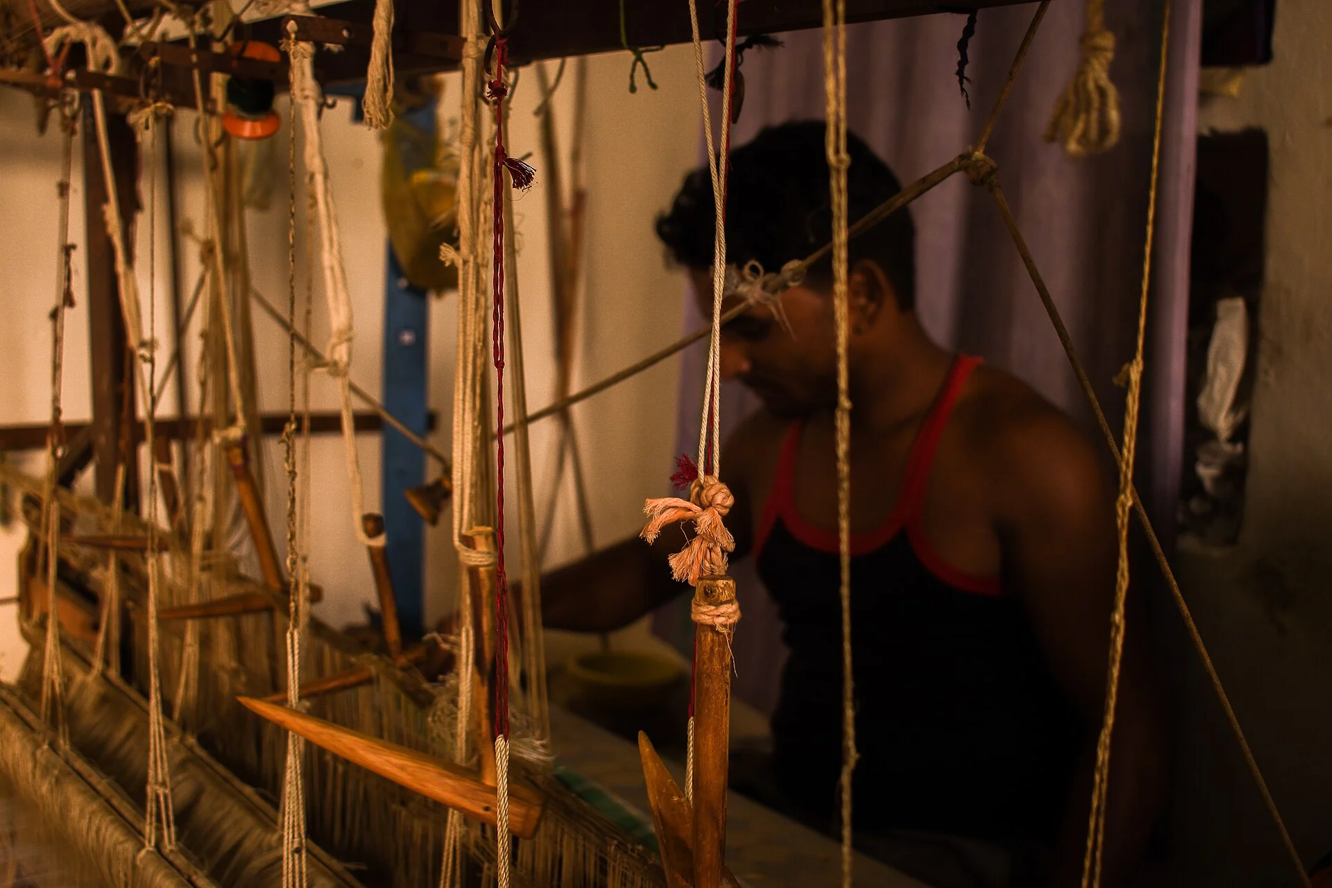 Indian handloom weaver working at a traditional loom