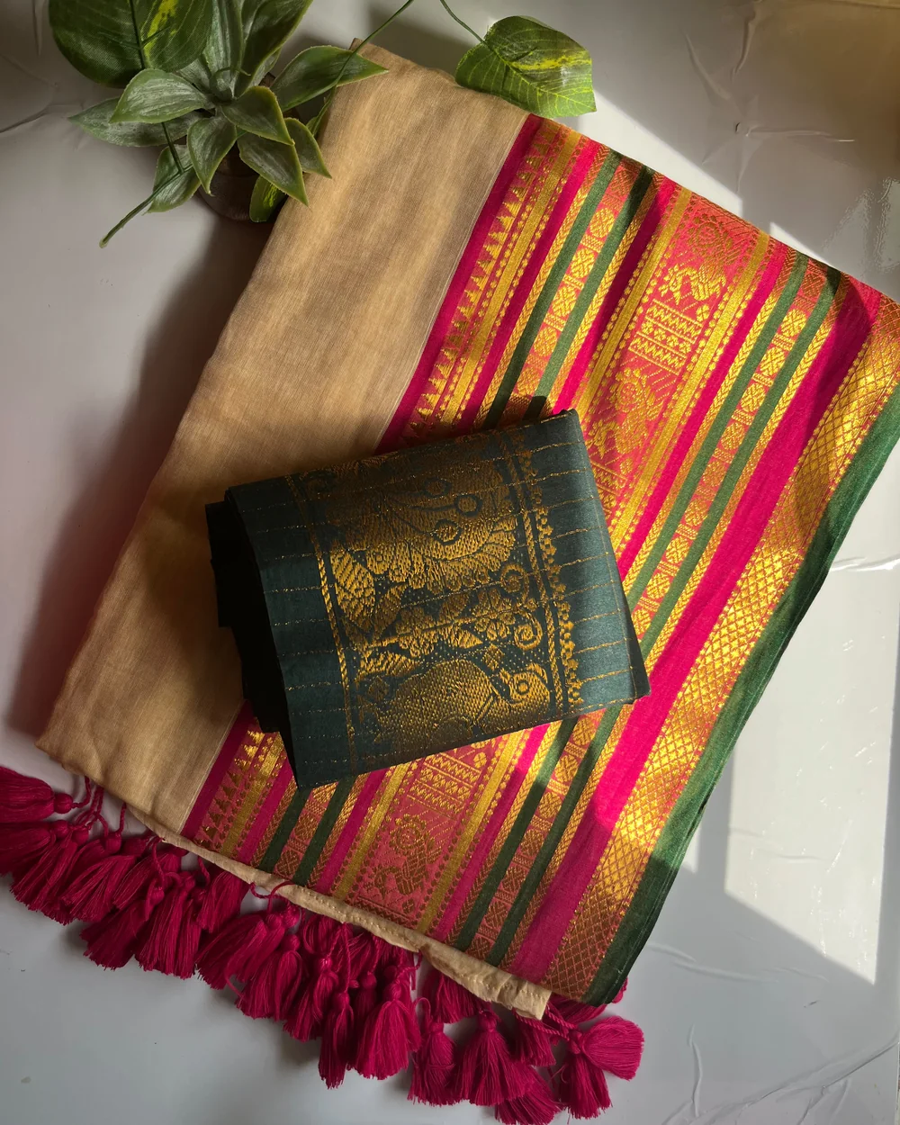 Sandal Kerala saree folded to show a broad Kanchi border woven with the annam swan motif
